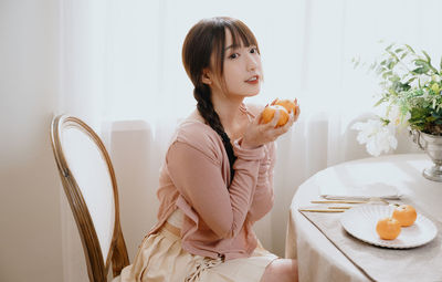 Young woman drinking coffee at home