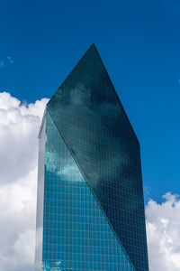 Low angle view of modern building against blue sky