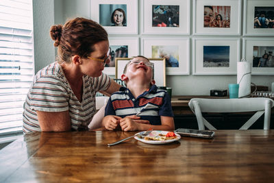 Mom holding boy while he is crying