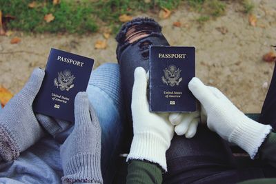 Midsection of people holding passports