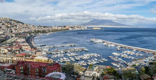Aerial view of naples with the port and vesuvio volcano at sunset
