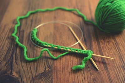 Close-up of knitting needle and wool on table