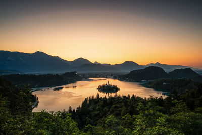 Scenic view of lake against sky during sunset