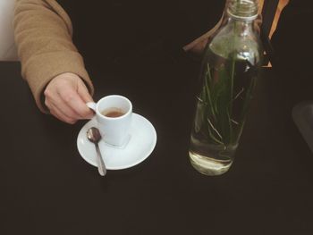 Midsection of man holding drink