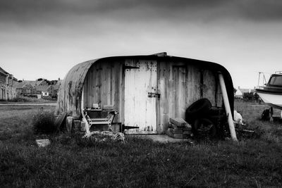 Abandoned truck on field against sky