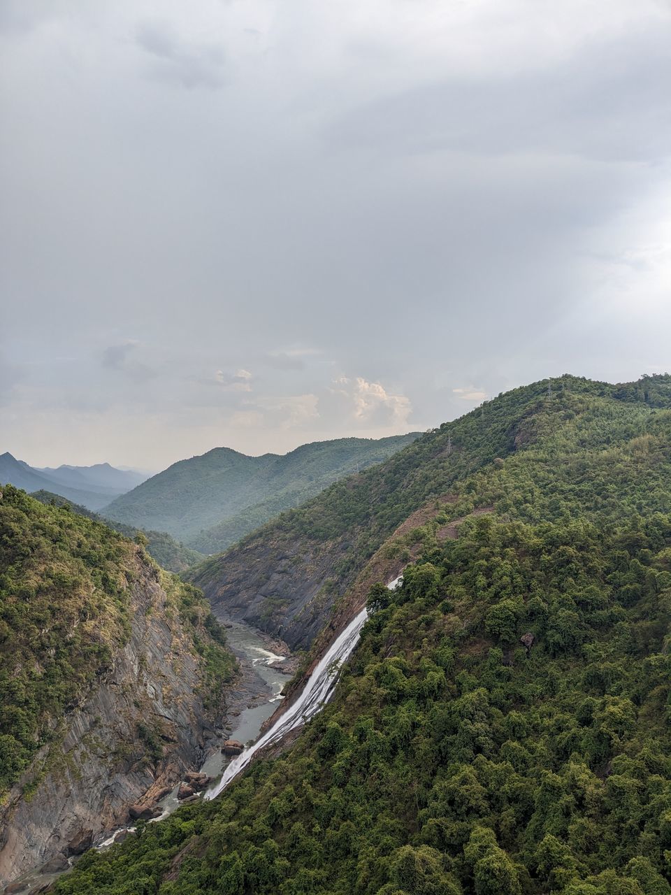 cloud, environment, mountain, scenics - nature, sky, landscape, beauty in nature, nature, land, plant, tree, no people, travel, mountain range, tranquility, non-urban scene, travel destinations, tranquil scene, outdoors, forest, tourism, overcast, day, fog, valley, high angle view, mountain pass, green, social issues, idyllic, road, ridge