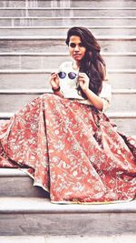 Portrait of a smiling young woman holding umbrella