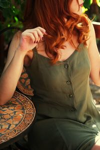 Midsection of woman sitting on seat