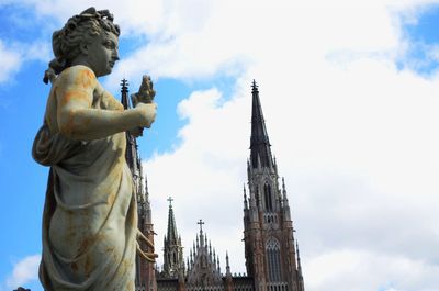 Low angle view of statue against cloudy sky