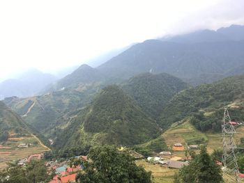 High angle view of buildings and mountains against sky