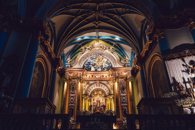 Low angle view of church altar at night
