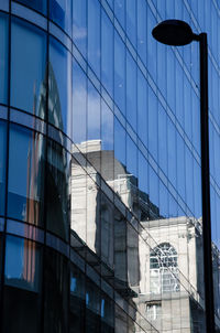 Reflection of built structures on glass building