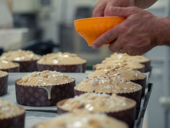 Cropped hand of chef preparing food