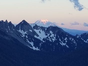 Scenic view of snowcapped mountains against sky during sunset