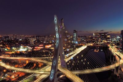 High angle view of illuminated buildings against sky at night