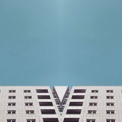 Low angle view of modern building against clear blue sky