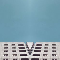Low angle view of modern building against clear blue sky