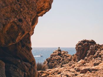 Scenic view of sea against clear sky from rocky shore