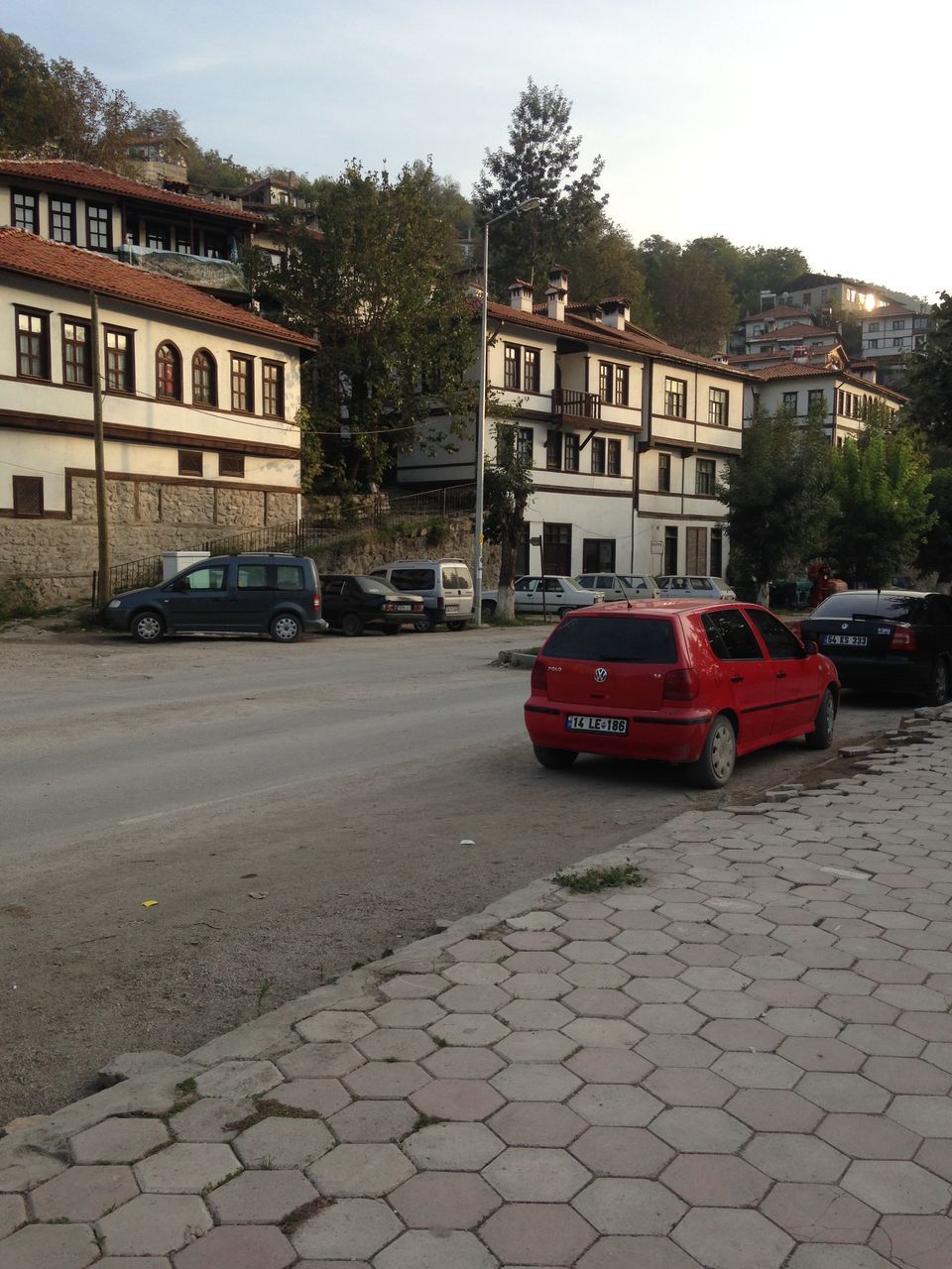 building exterior, architecture, built structure, street, residential structure, residential building, city, house, building, car, transportation, tree, road, day, the way forward, clear sky, city life, outdoors, incidental people, land vehicle