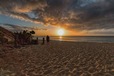 Scenic view of beach against sky during sunset