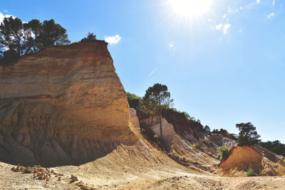 Rock formation against sky on sunny day