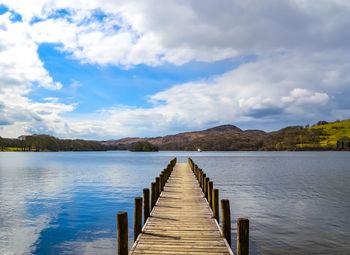 Pier over lake against sky