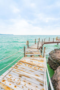 Pier over sea against sky