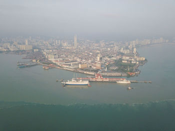 High angle view of sea and buildings in city