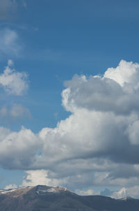 Scenic view of mountains against blue sky