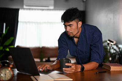 Man using laptop at home