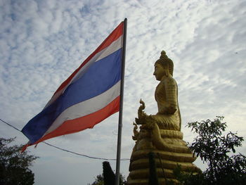 Low angle view of statue against sky