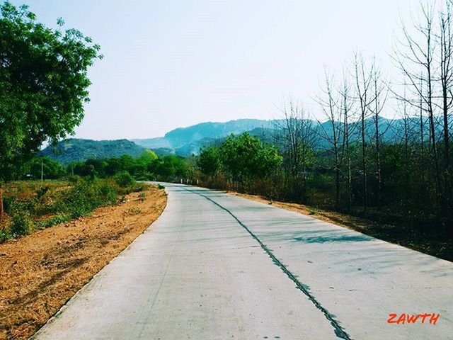 the way forward, clear sky, diminishing perspective, road, tree, vanishing point, transportation, tranquility, tranquil scene, mountain, landscape, country road, scenics, nature, sky, empty, long, non-urban scene, beauty in nature, empty road