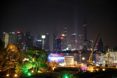 Commercial dock with skyscrapers in background at night