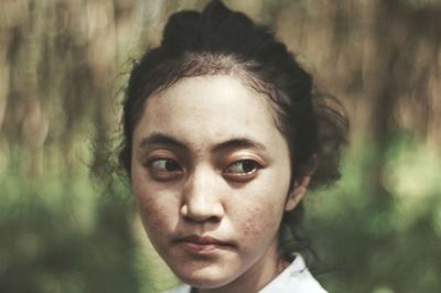 Close-up portrait of young woman outdoors