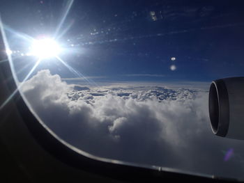 Cropped image of airplane wing over landscape