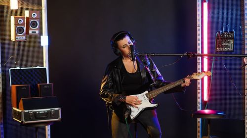 Portrait of young man playing guitar