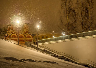 Illuminated railing against sky at night during winter