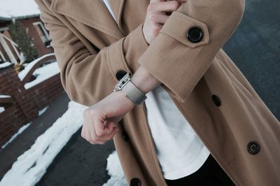 Midsection of woman with wristwatch