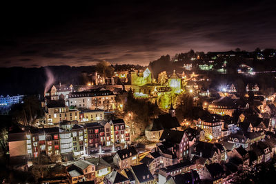 High angle view of illuminated cityscape against sky at night