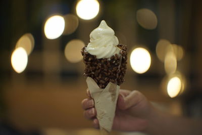 Close-up of hand holding ice cream cone