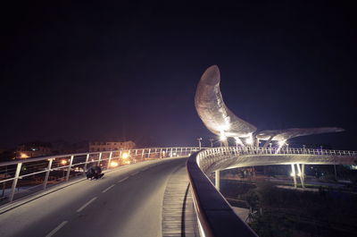 Illuminated bridge at night