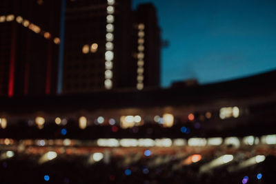 Defocused image of illuminated city at night