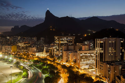 High angle view of city lit up at night