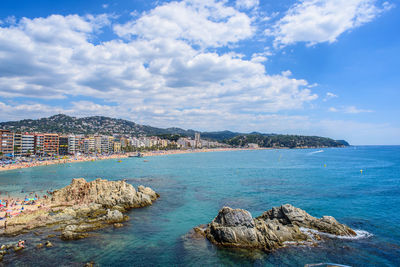 Scenic view of sea by city against sky