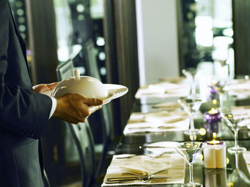 Hand holding drink in restaurant