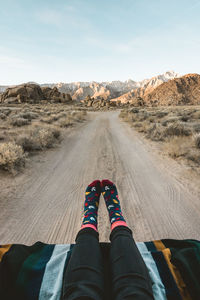 Low section of woman wearing socks at desert