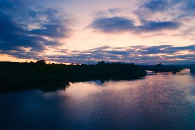 Scenic view of calm lake at sunset