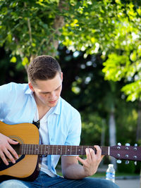 Full length of man playing guitar