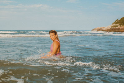 Young woman standing at beach