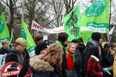 People on street against trees